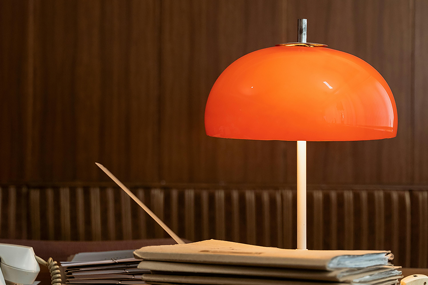 Orange lamp on desk with documents - Payroll - we take care of all your payroll, SARS and UIF and Compensation Fund needs.