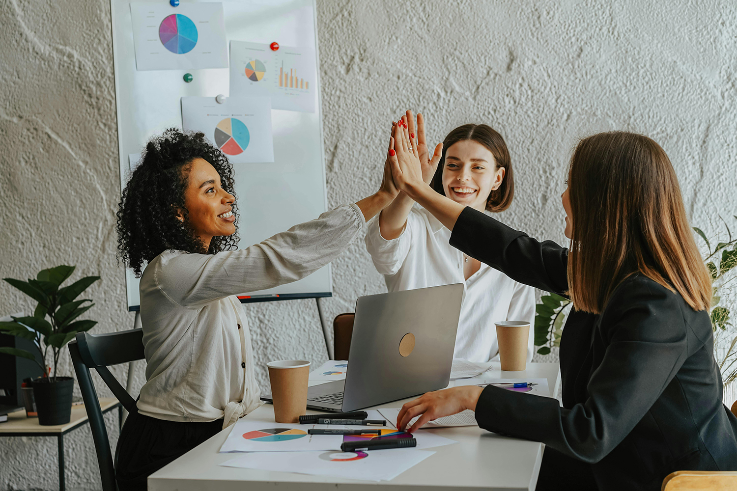 Three women hi-five each other in boardroom. Estate taxes - the computation of all taxes due on date of death, including calculation of any taxes due and advising on roll-over provisions with the best tax advice and planning.